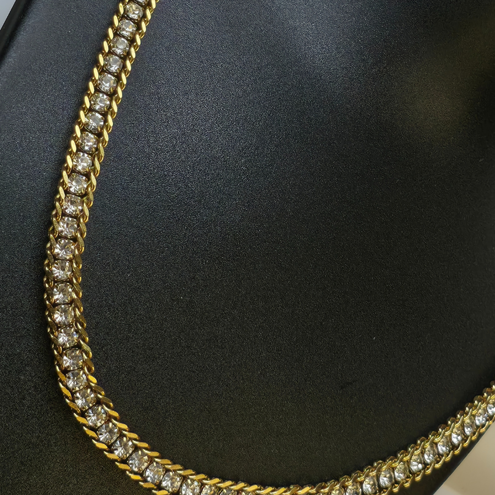 Gold-plated, iced-out tennis chain necklace and matching bracelet.