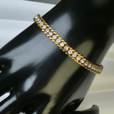 Gold-plated, iced-out tennis chain necklace and matching bracelet.