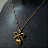 Gold-plated bow-heart necklace and earring set.